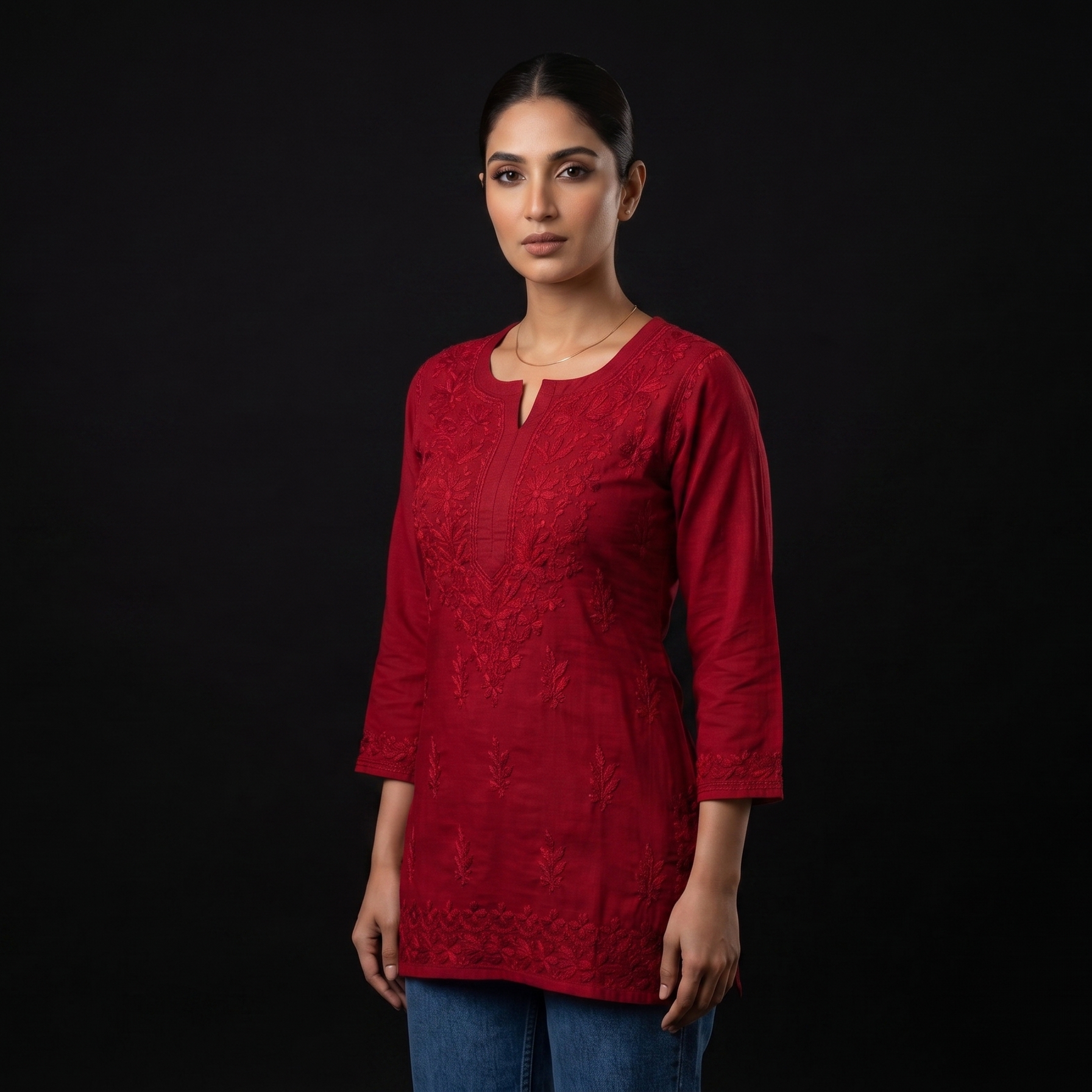 Woman wearing a red kurta against a black background