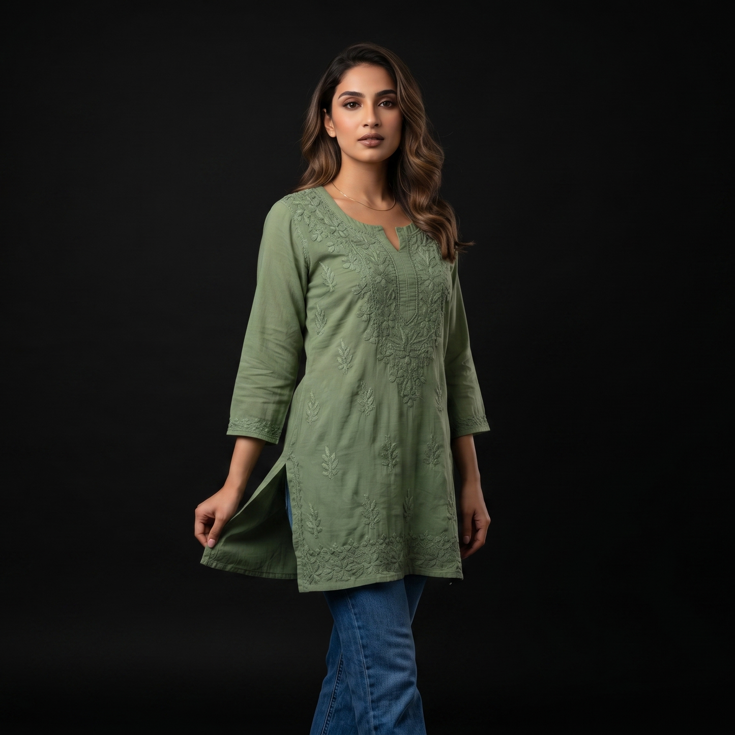 Woman wearing a green dress against a black background