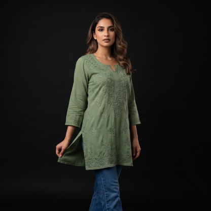 Woman wearing a green dress against a black background