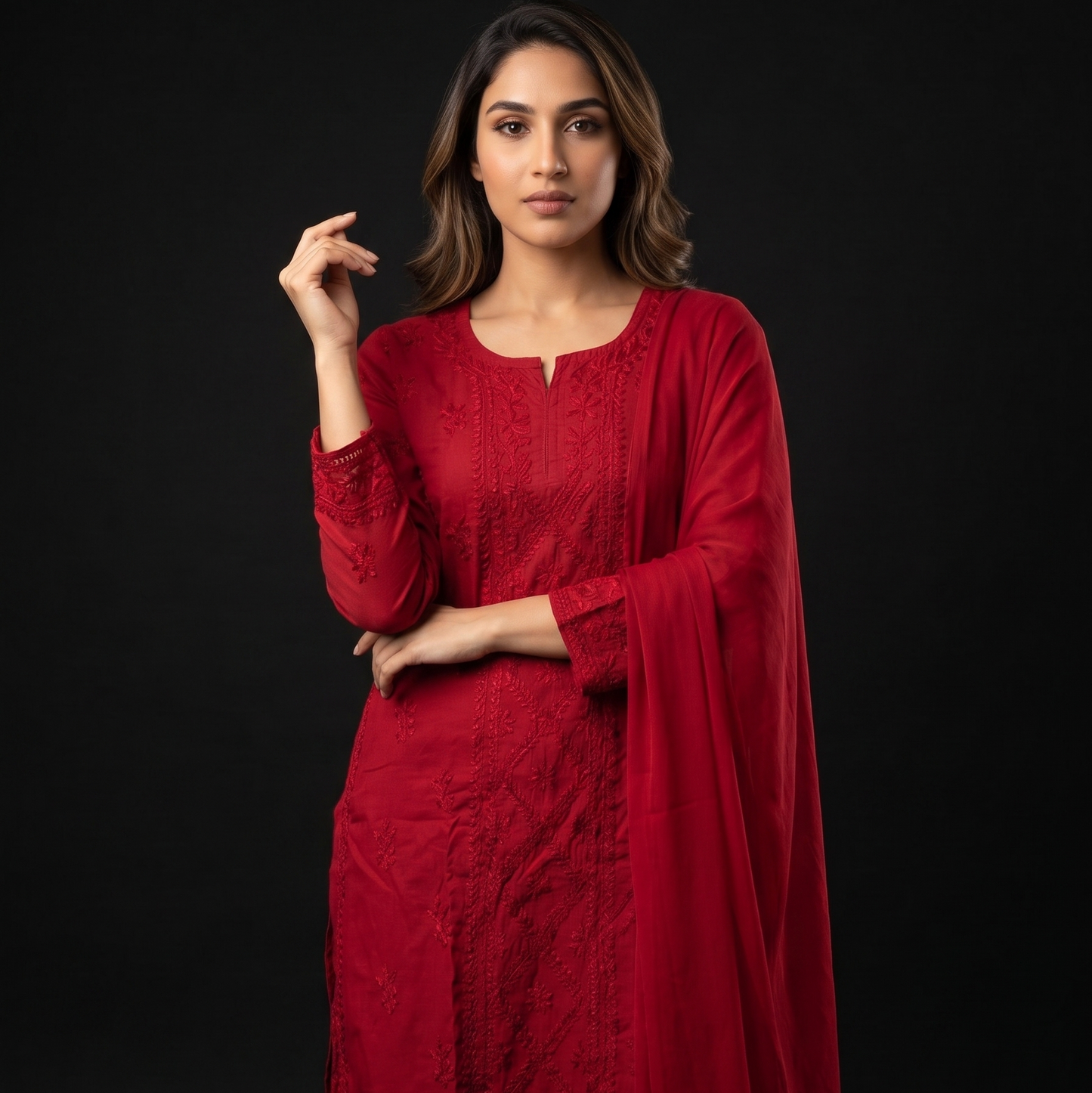 Woman wearing a red traditional outfit with a black background